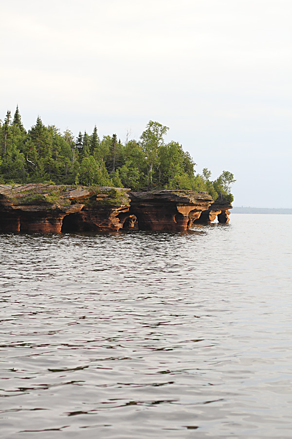 Over time the water has weathered deep caves into the sandstone. Apparently you can reach these caves over ice in the winter time and the ice formations within them are amazing. We heard quite a few interesting stories about traveling over ice roads from our boat captain, a native of the area.